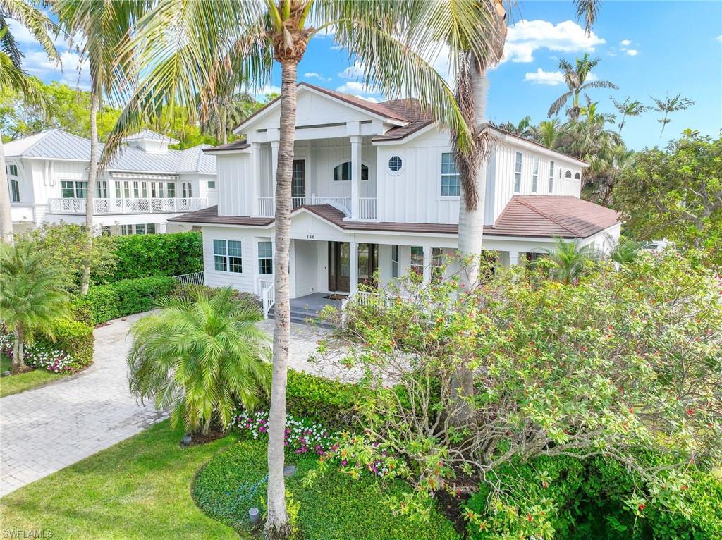 160 3rd Street North Naples, FL 34102 - Photo 3 of 48 a view of a white house with a yard and plants