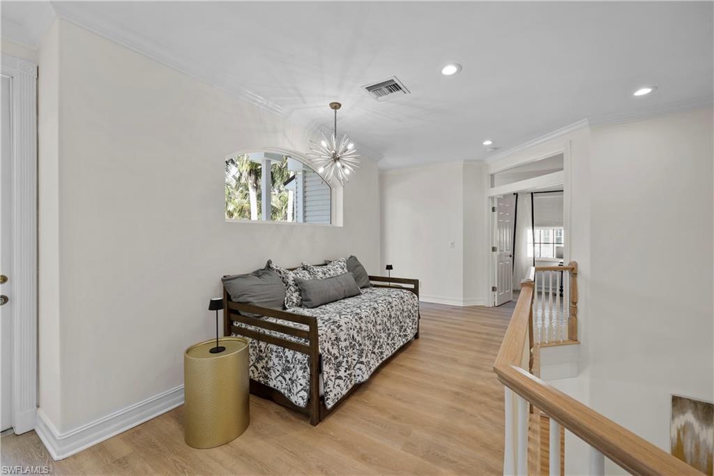 160 3rd Street North Naples, FL 34102 - Photo 31 of 48 a living room with furniture and a chandelier
