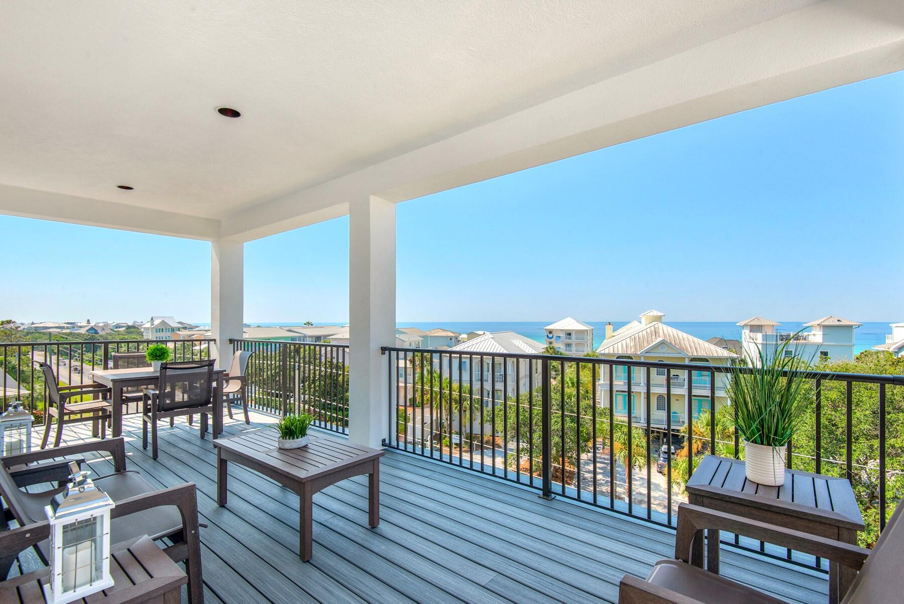 78 Cote D Azur Drive Santa Rosa Beach, FL 32459 - Photo 2 of 80 a view of a balcony with chairs and wooden floor