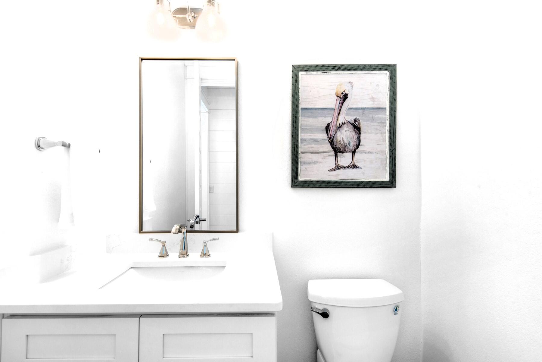 78 Cote D Azur Drive Santa Rosa Beach, FL 32459 - Photo 21 of 80 a bathroom with a toilet sink and mirror