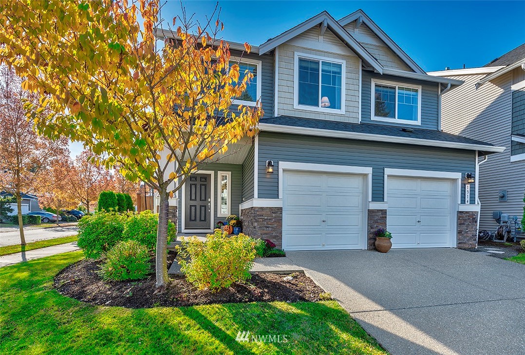 a front view of a house with a garden