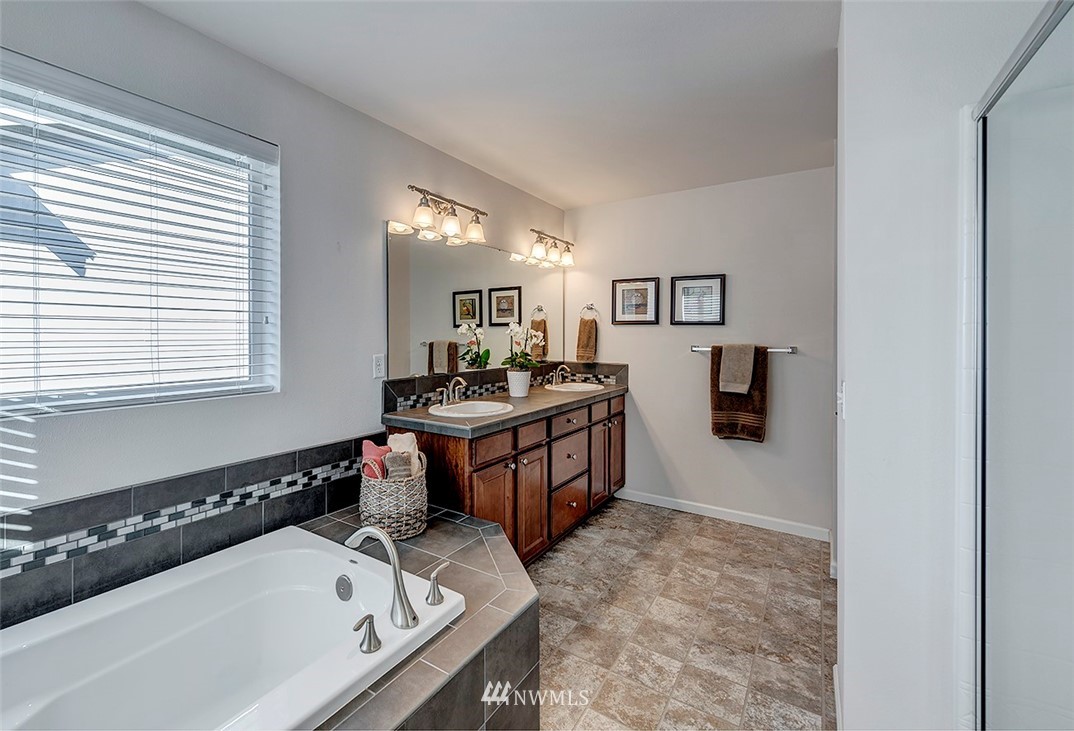 1314 124th Place Southeast Everett, WA 98208 - Photo 12 of 23 a bathroom with a bathtub sink and mirror