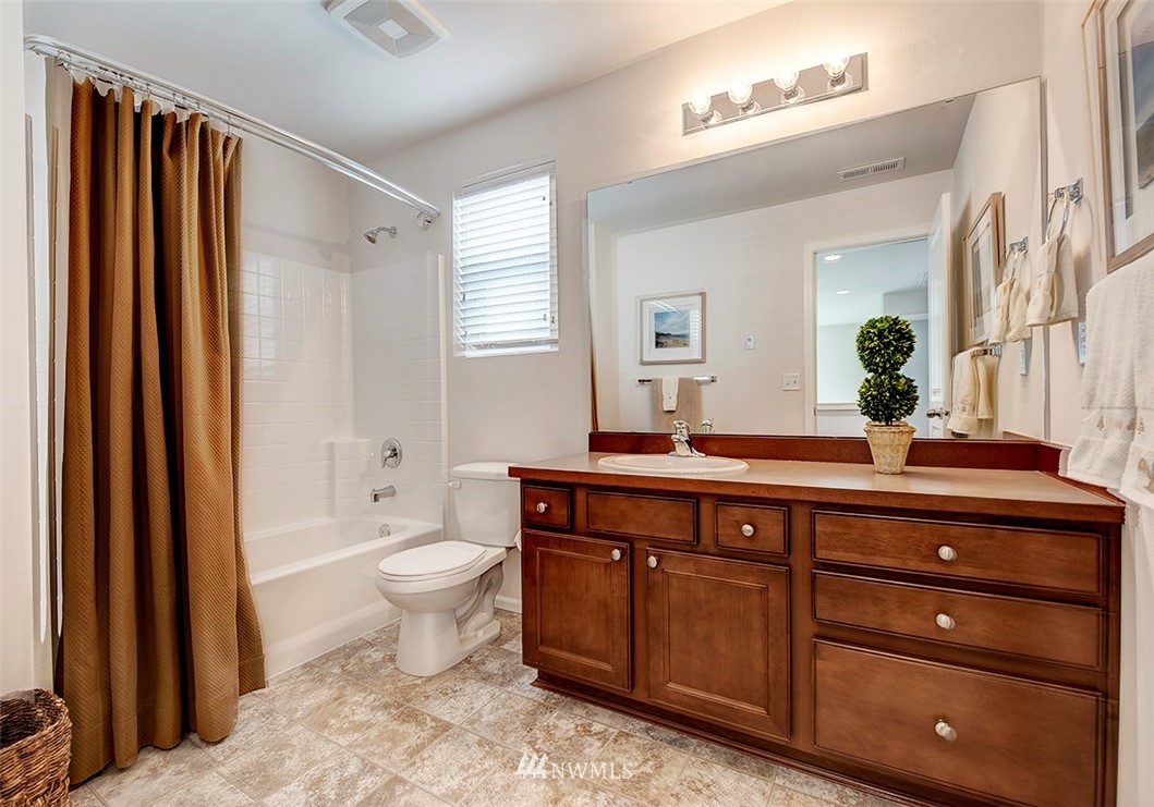 1314 124th Place Southeast Everett, WA 98208 - Photo 14 of 23 a spacious bathroom with a granite countertop sink toilet and a mirror