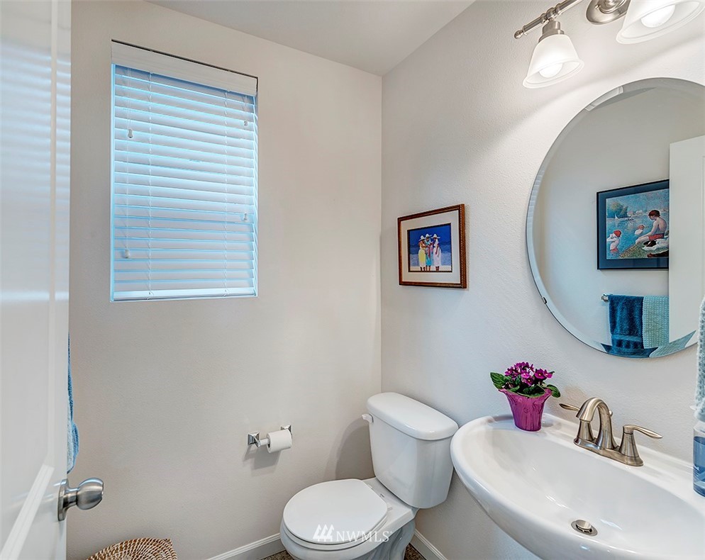 1314 124th Place Southeast Everett, WA 98208 - Photo 8 of 23 a bathroom with a toilet a sink and a mirror