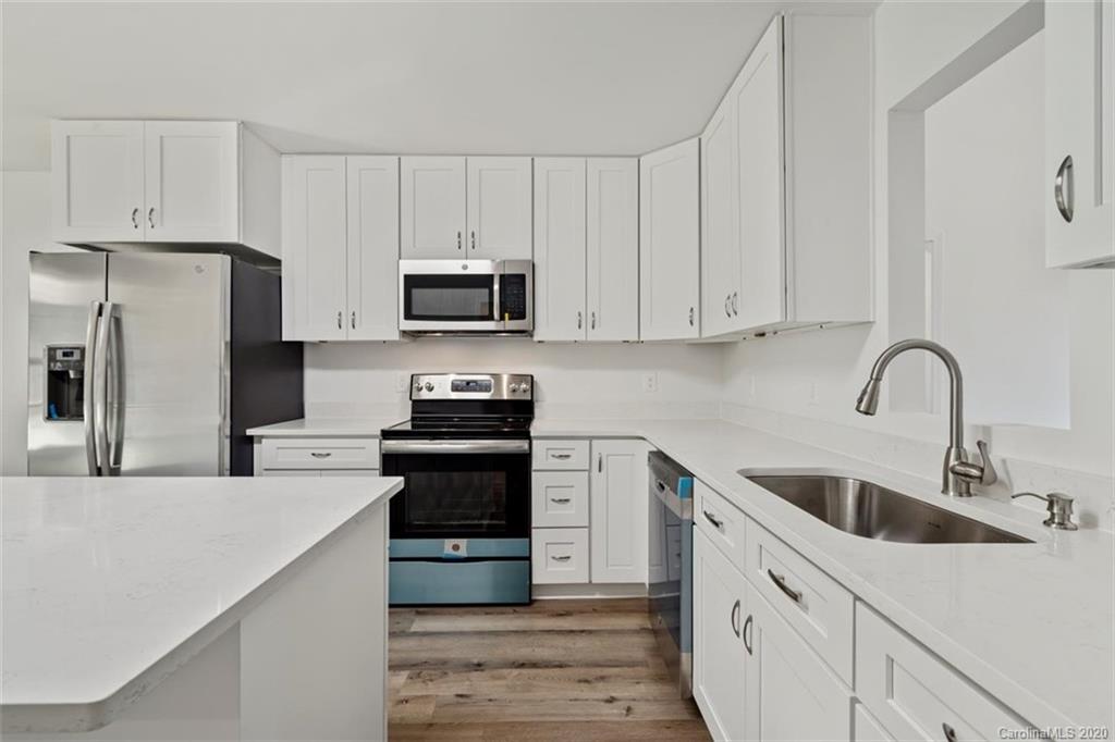 2979 Greenleaf Road, Unit 5 Clover, SC 29710 - Photo 11 of 46 a kitchen with cabinets stainless steel appliances and a sink
