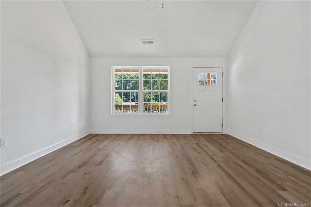 2979 Greenleaf Road, Unit 5 Clover, SC 29710 - Photo 13 of 46 an empty room with wooden floor and windows