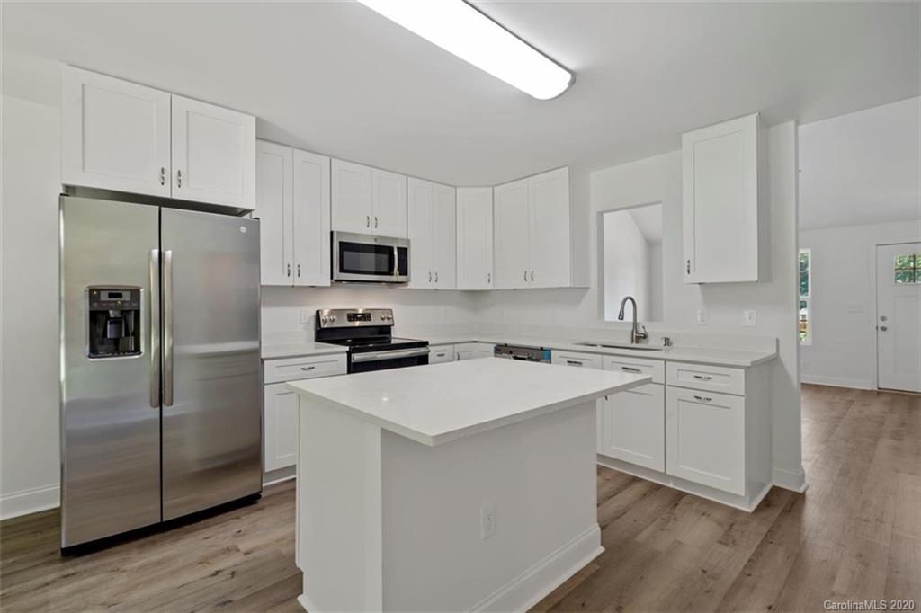 2979 Greenleaf Road, Unit 5 Clover, SC 29710 - Photo 17 of 46 a kitchen with white cabinets and stainless steel appliances