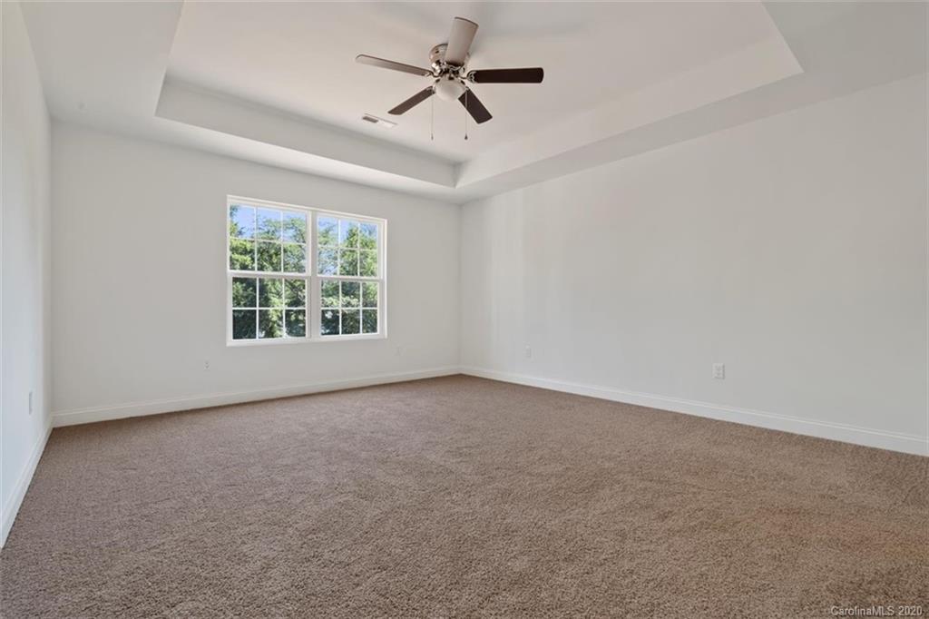 2979 Greenleaf Road, Unit 5 Clover, SC 29710 - Photo 20 of 46 an empty room with windows and ceiling fan