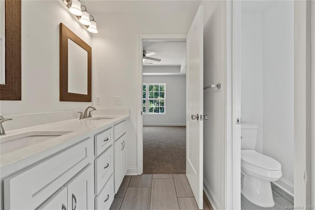 2979 Greenleaf Road, Unit 5 Clover, SC 29710 - Photo 23 of 46 a spacious bathroom with a granite countertop sink mirror and a toilet