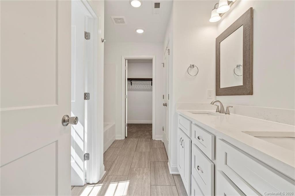 2979 Greenleaf Road, Unit 5 Clover, SC 29710 - Photo 24 of 46 a bathroom with a sink a mirror and a shower