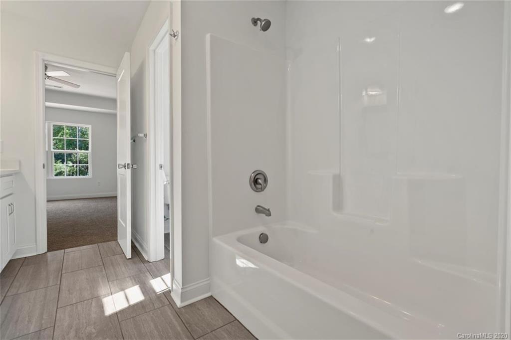 2979 Greenleaf Road, Unit 5 Clover, SC 29710 - Photo 25 of 46 a bathroom with a bathtub and a shower