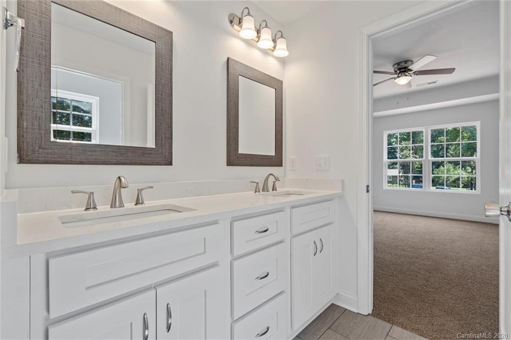 2979 Greenleaf Road, Unit 5 Clover, SC 29710 - Photo 28 of 46 a bathroom with double sink and a mirror
