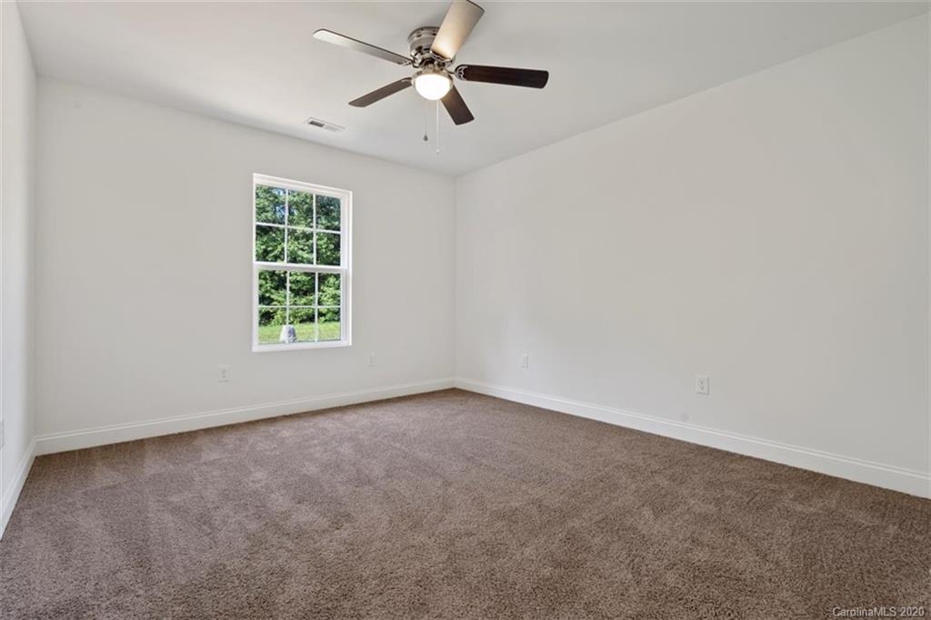 2979 Greenleaf Road, Unit 5 Clover, SC 29710 - Photo 29 of 46 an empty room with windows and fan