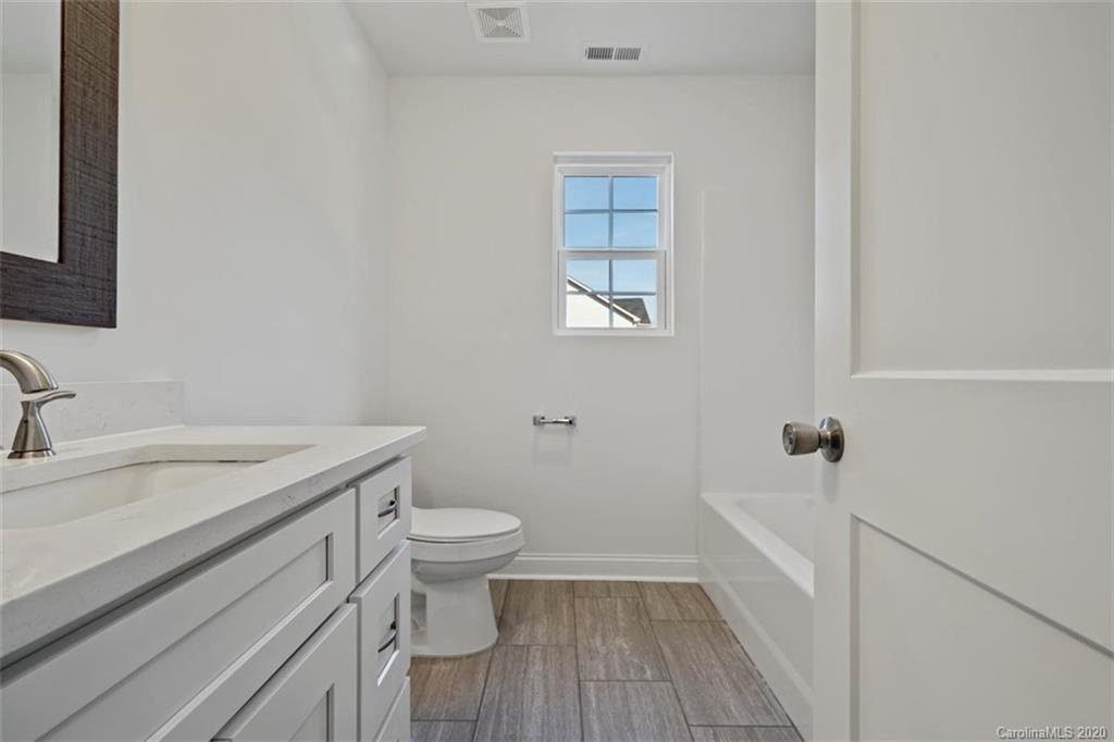 2979 Greenleaf Road, Unit 5 Clover, SC 29710 - Photo 31 of 46 a bathroom with a sink toilet and vanity