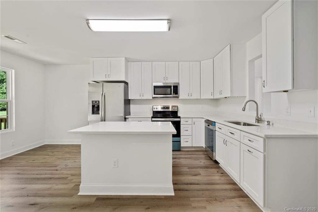 2979 Greenleaf Road, Unit 5 Clover, SC 29710 - Photo 10 of 46 a kitchen with stainless steel appliances granite countertop a stove top oven a sink dishwasher and a refrigerator