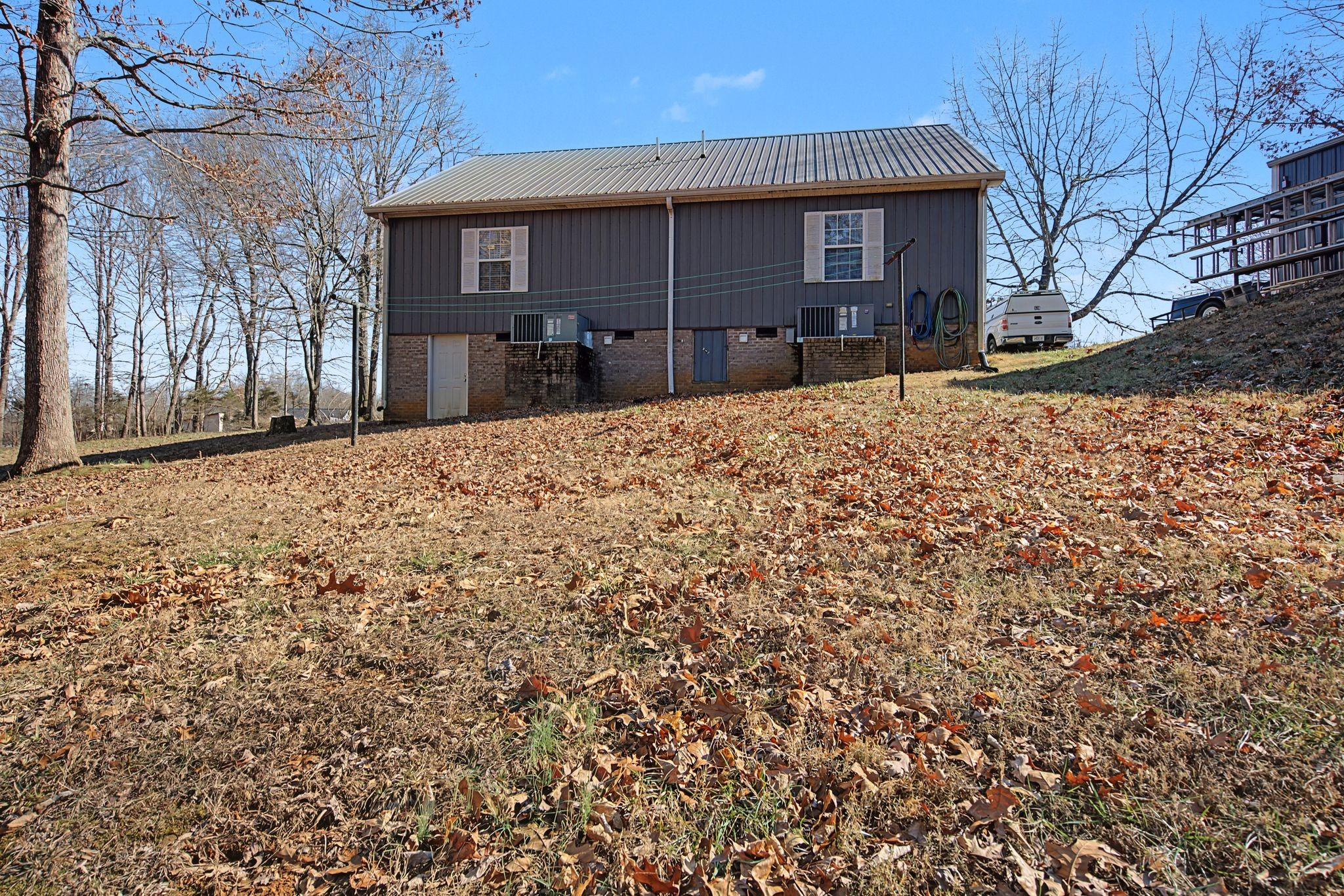 1075 Coker Ford Road Portland, TN 37148 - Photo 35 of 35 a front view of a house with a yard covered in snow