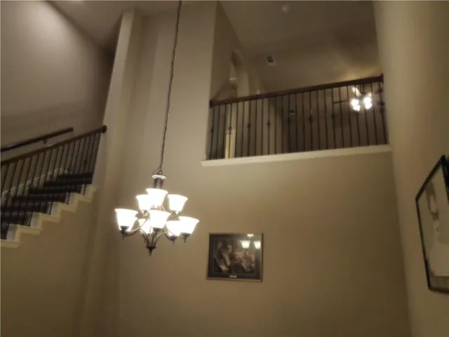 a bathroom with a light fixture and a chandelier fan