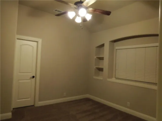 a dining room with furniture a chandelier and window