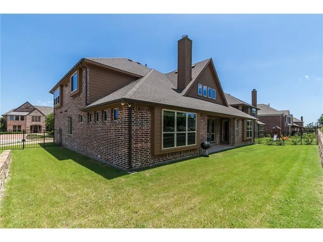 a view of a house with a yard and garden