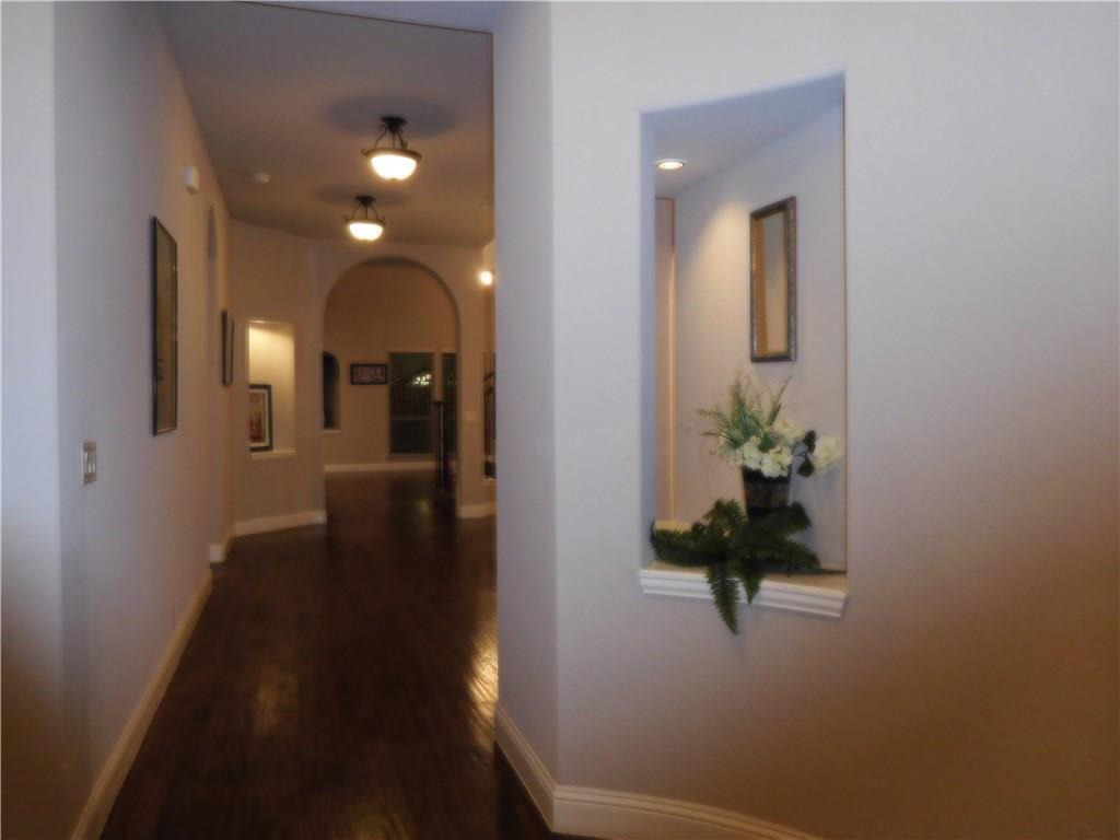 961 Crystal Falls Drive Prosper, TX 75078 - Photo 4 of 33 a view of a hallway with wooden floor and a bathroom