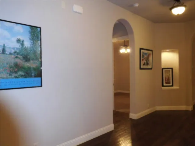 a view of a hallway with wooden floor