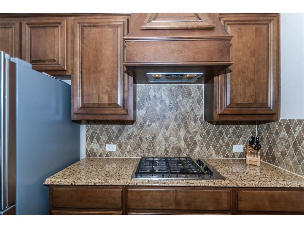 961 Crystal Falls Drive Prosper, TX 75078 - Photo 10 of 33 a kitchen with stainless steel appliances granite countertop a sink and cabinets
