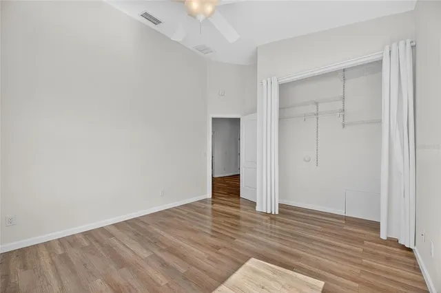 a view of an empty room with wooden floor