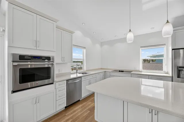 a kitchen with a stove a sink and a refrigerator