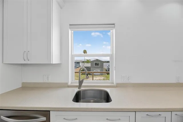 a kitchen with a sink and cabinets
