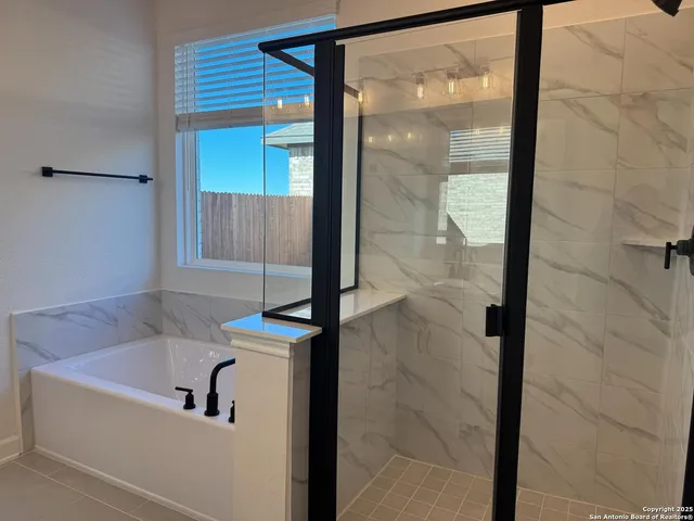 a bathroom with a bathtub and a shower