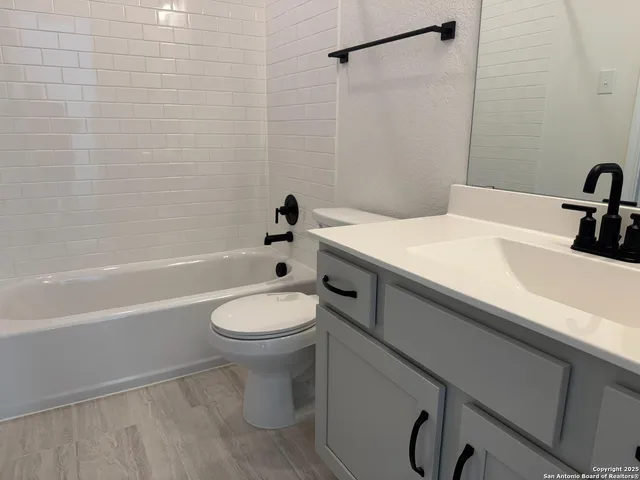 a bathroom with a sink a toilet and a bathtub
