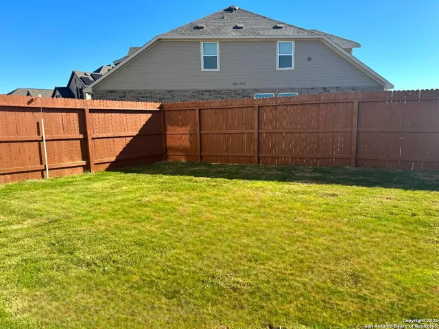 a view of a backyard of the house