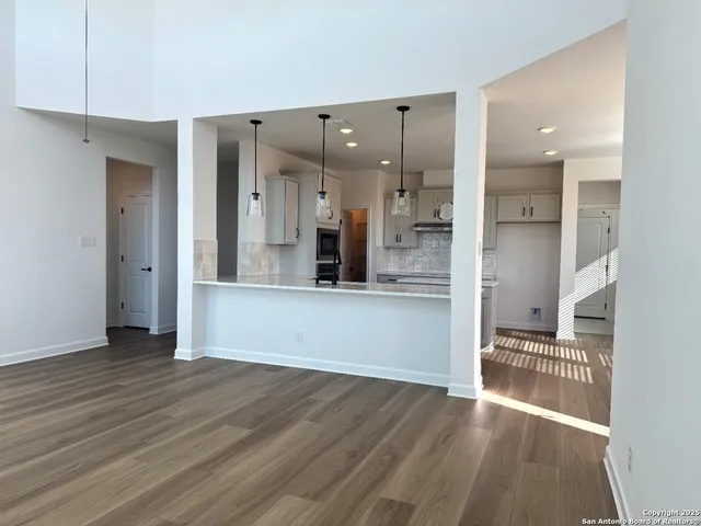 a view of a kitchen cabinets and a kitchen with wooden floor