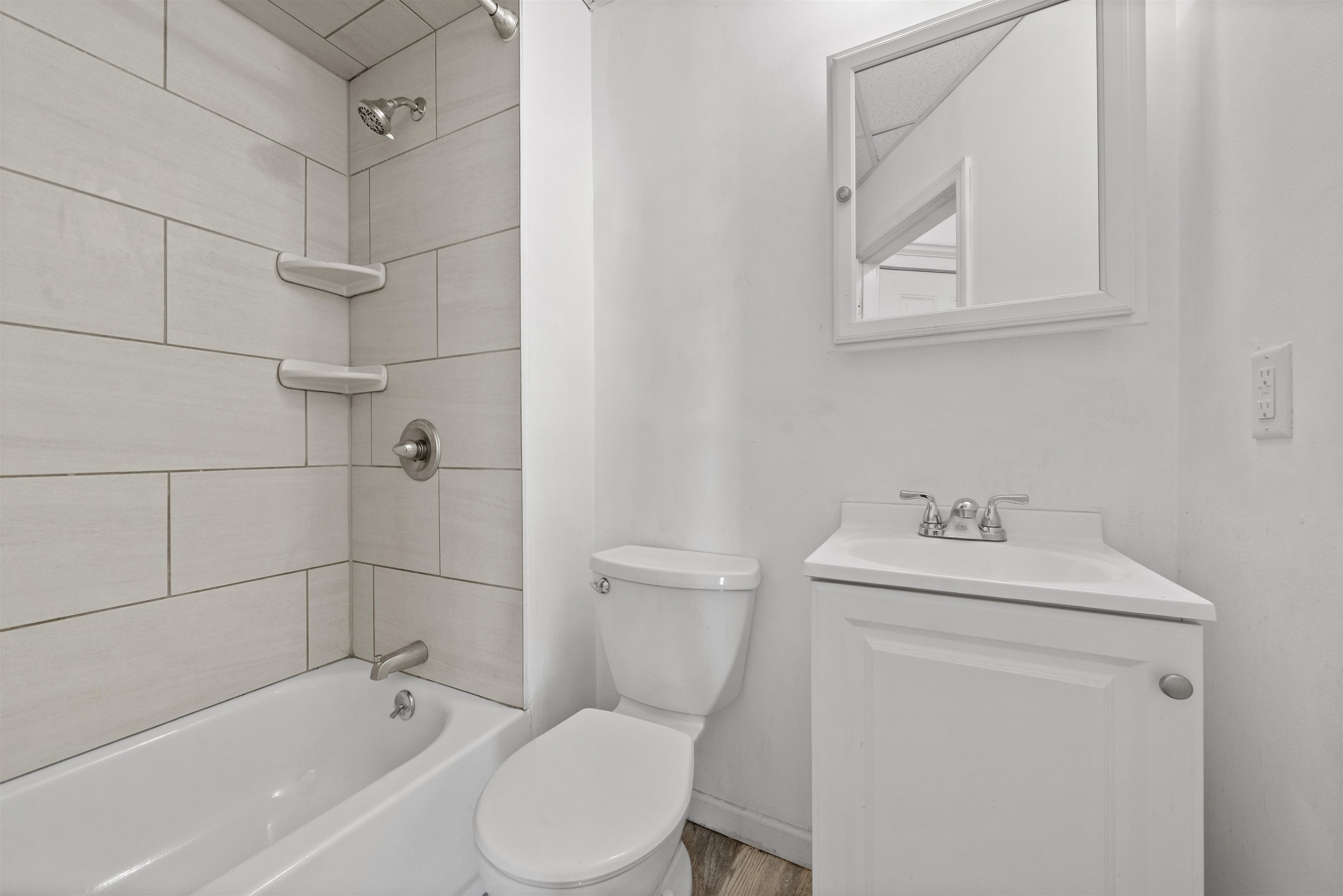 21 Walnut Street, Unit 2 Clifton, NJ 07013 - Photo 11 of 14 a bathroom with a sink a toilet and shower