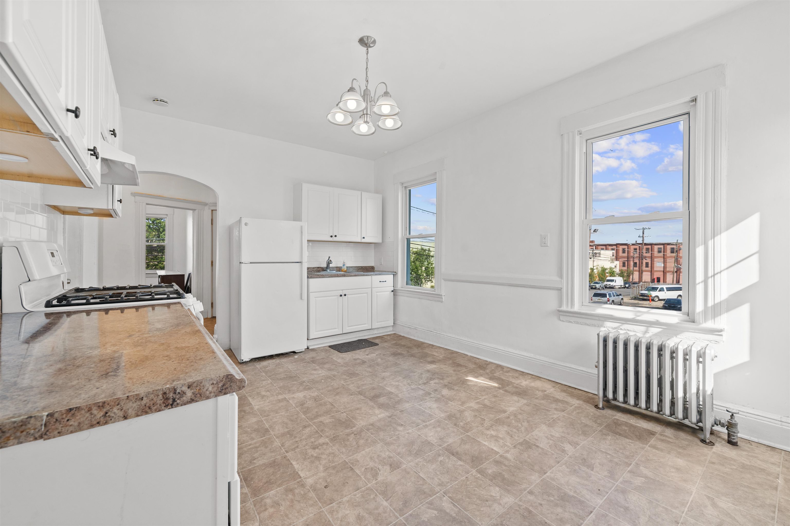 21 Walnut Street, Unit 2 Clifton, NJ 07013 - Photo 2 of 14 a view of a kitchen with a sink cabinets and outdoor space