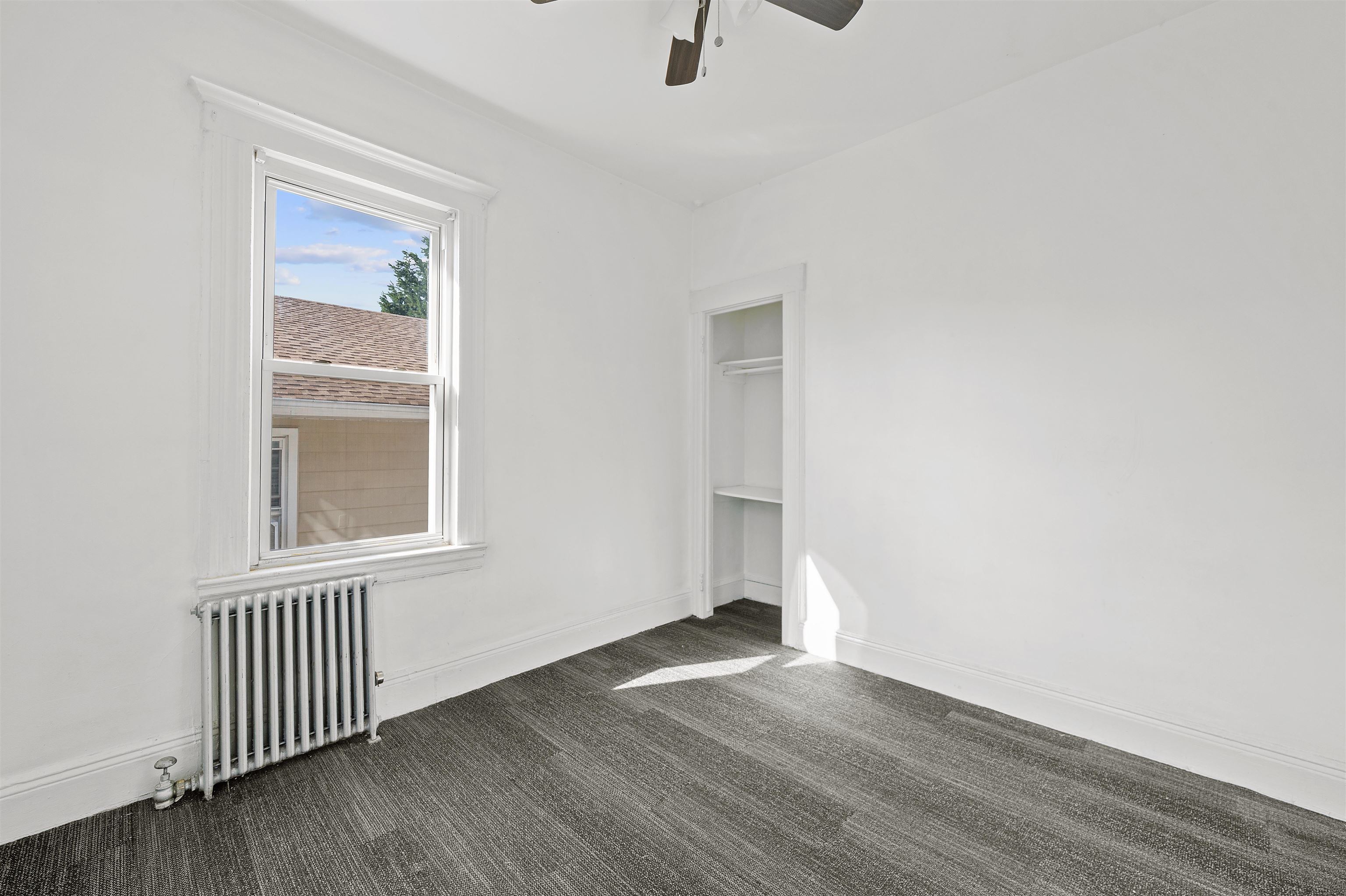 21 Walnut Street, Unit 2 Clifton, NJ 07013 - Photo 9 of 14 an empty room with wooden floor and windows