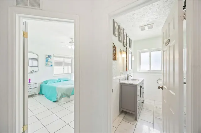 a bathroom with a tub shower and sink