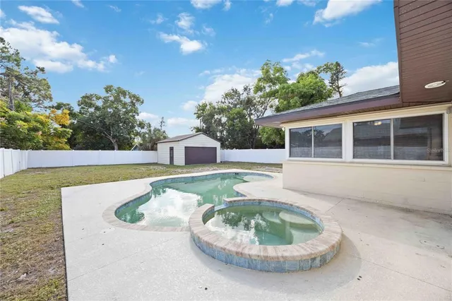 a view of a house with a swimming pool and a yard