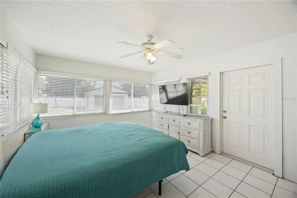 a spacious bedroom with a bed and a window