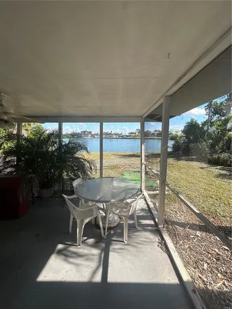 a living room with a floor to ceiling window and pool table