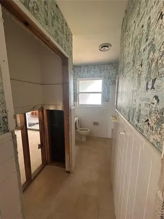 a view of hallway with furniture and windows