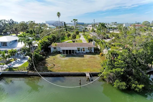 an aerial view of a swimming pool with table and chairs