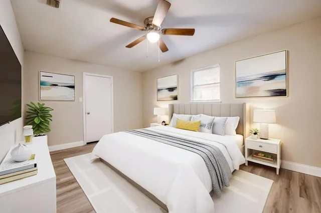 a bed room with a bed and a chandelier