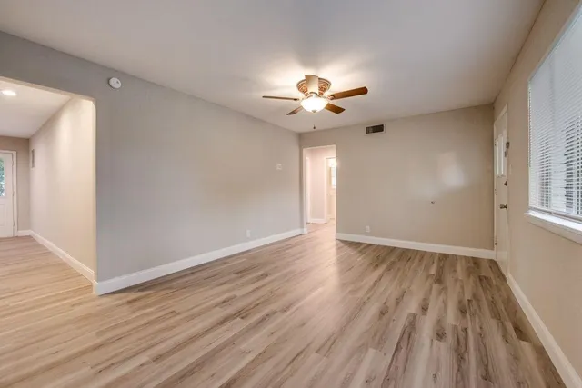 wooden floor in an empty room with a window
