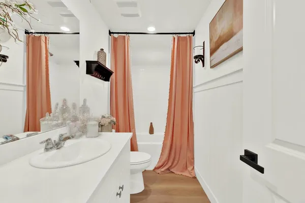 a bathroom with a sink toilet and shower