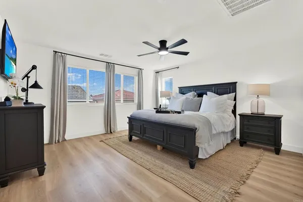 a spacious bedroom with a bed and a window