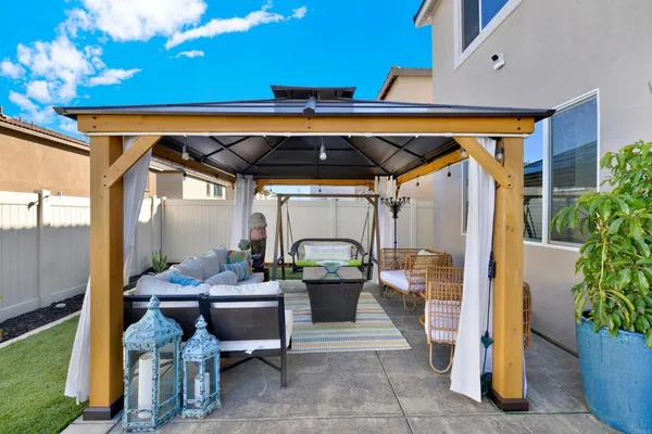 a backyard of a house with table and chairs
