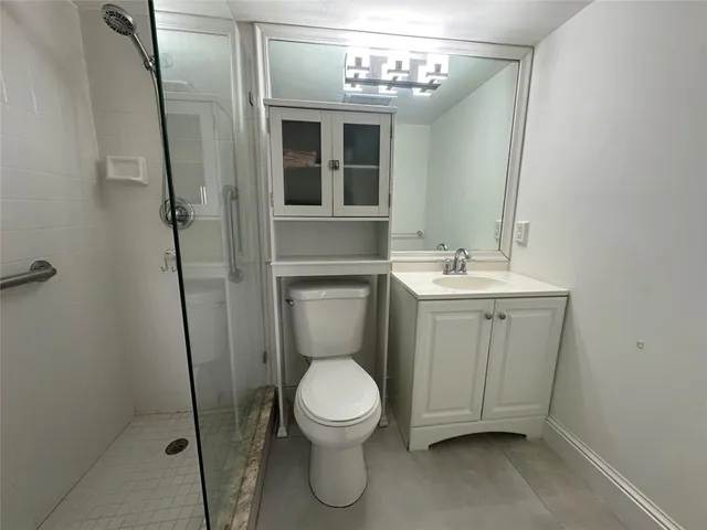 a bathroom with a toilet sink and shower