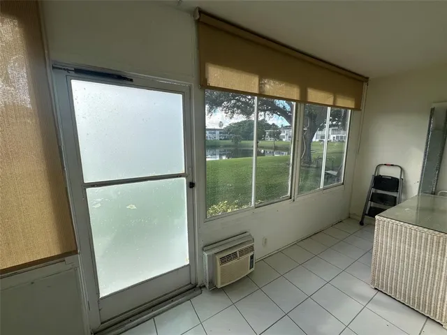 a kitchen with a refrigerator and a large window