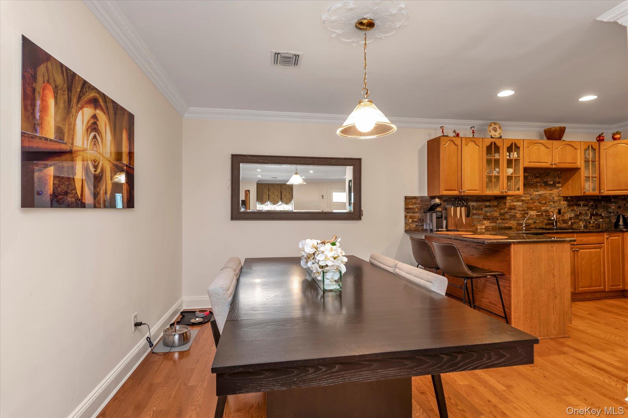 150 I U Willets Road Albertson, NY 11507 - Photo 9 of 21 Open concept dining room leading to open kitchen with stainlees steel appliances and wsher dryer.